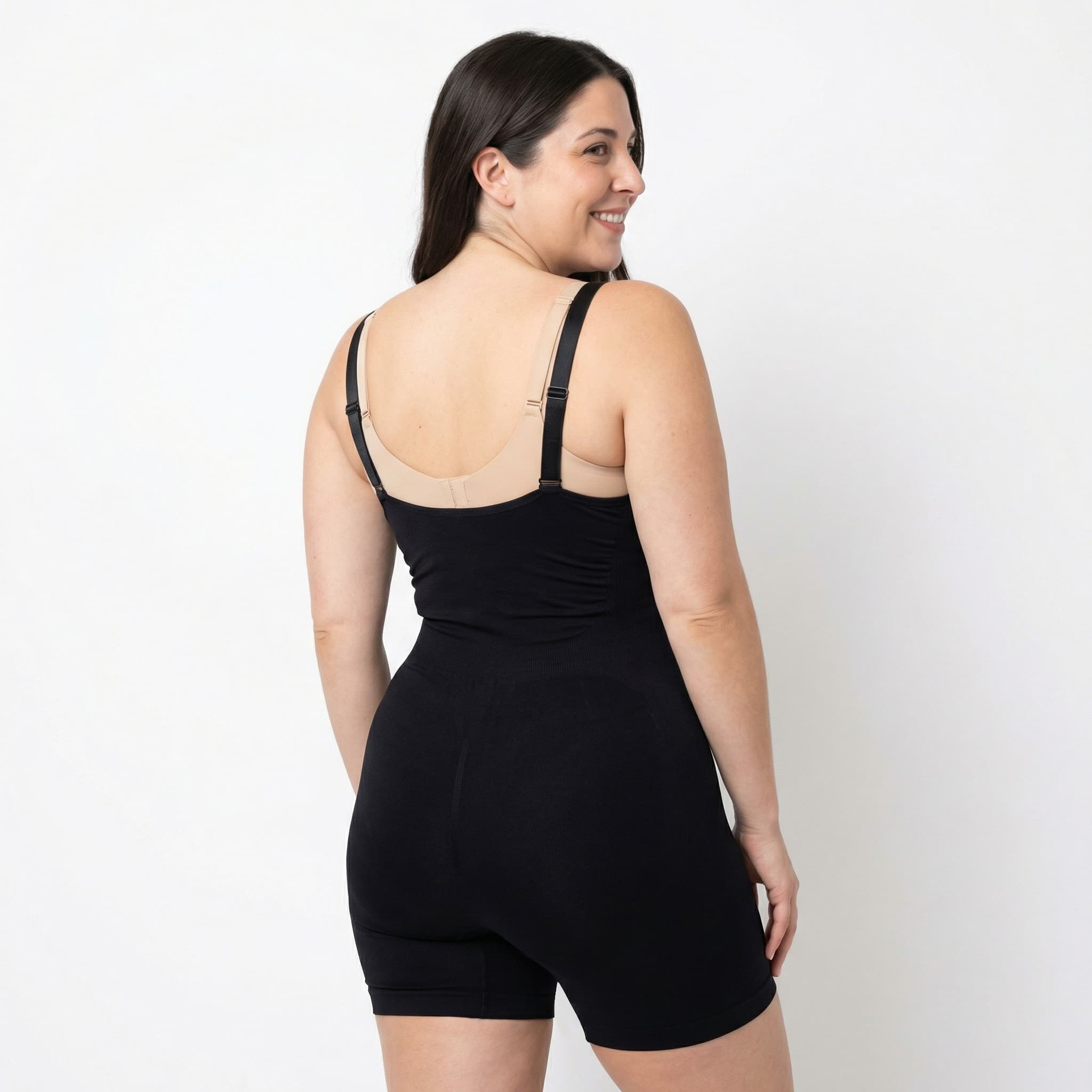 Woman in black ribbed bodysuit, studio back view