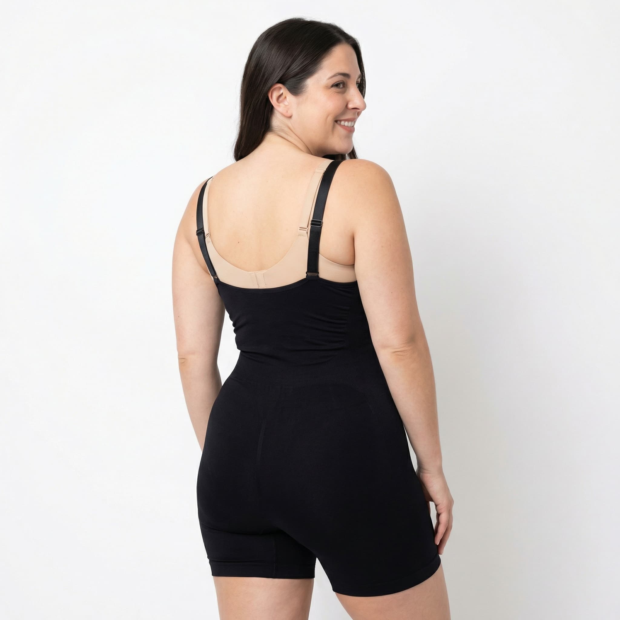 Woman in black ribbed bodysuit, studio back view