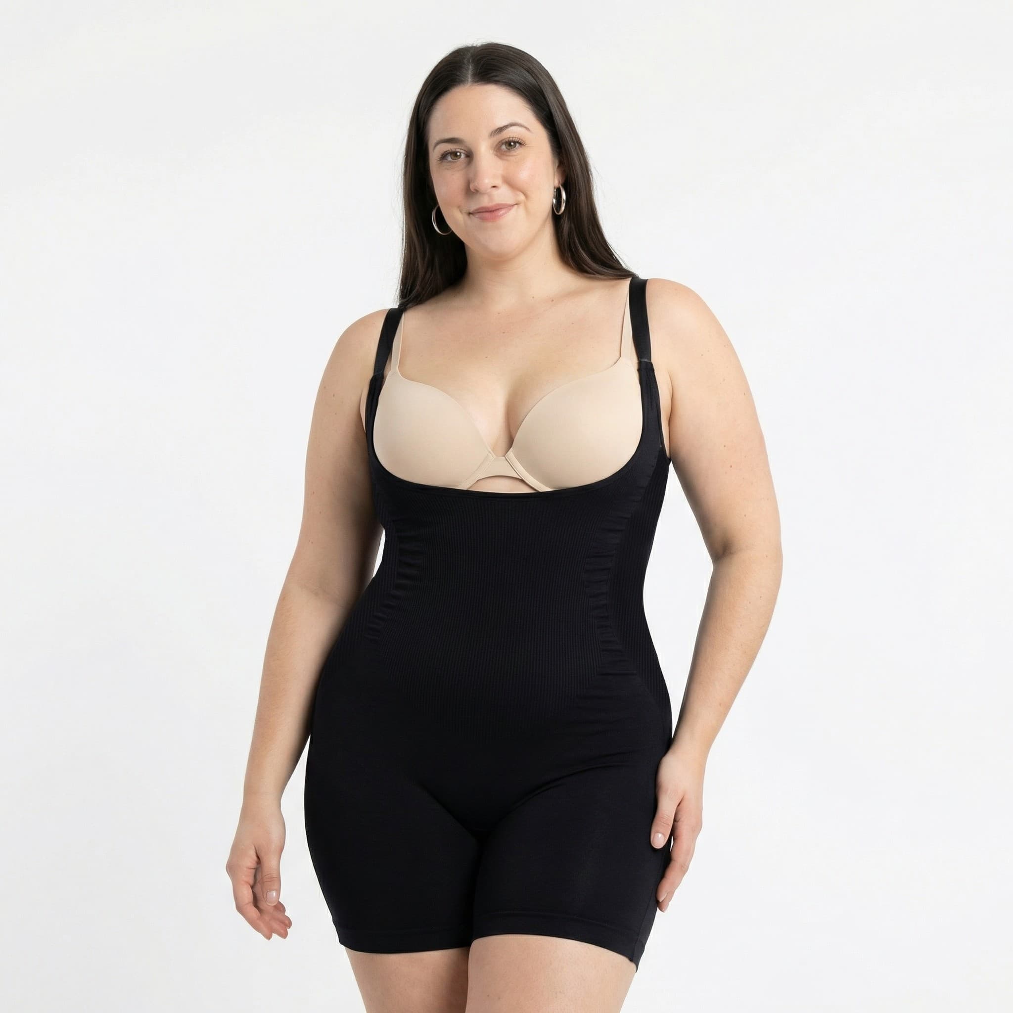 Woman in black ribbed bodysuit, studio front view