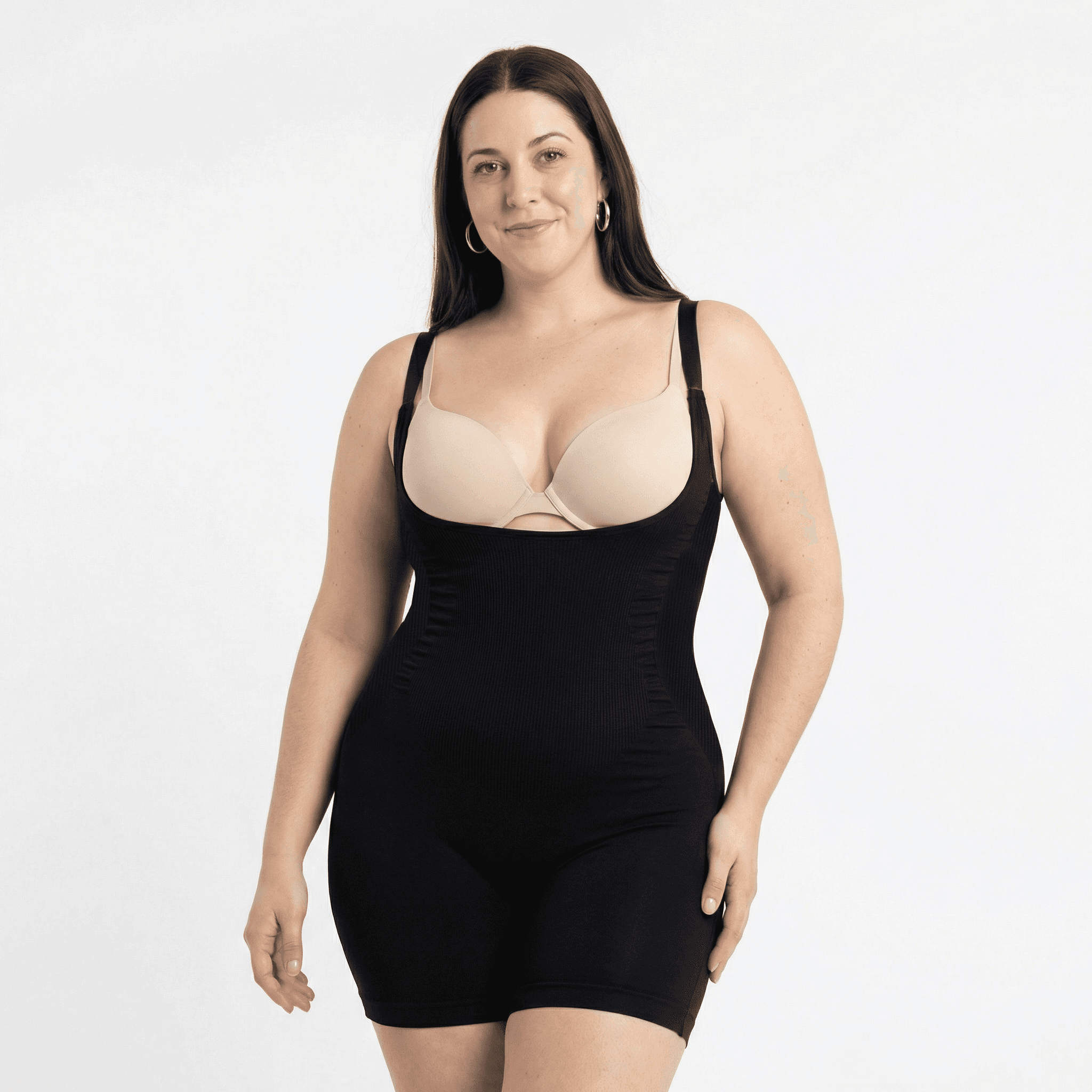 Woman in black ribbed bodysuit, studio front view