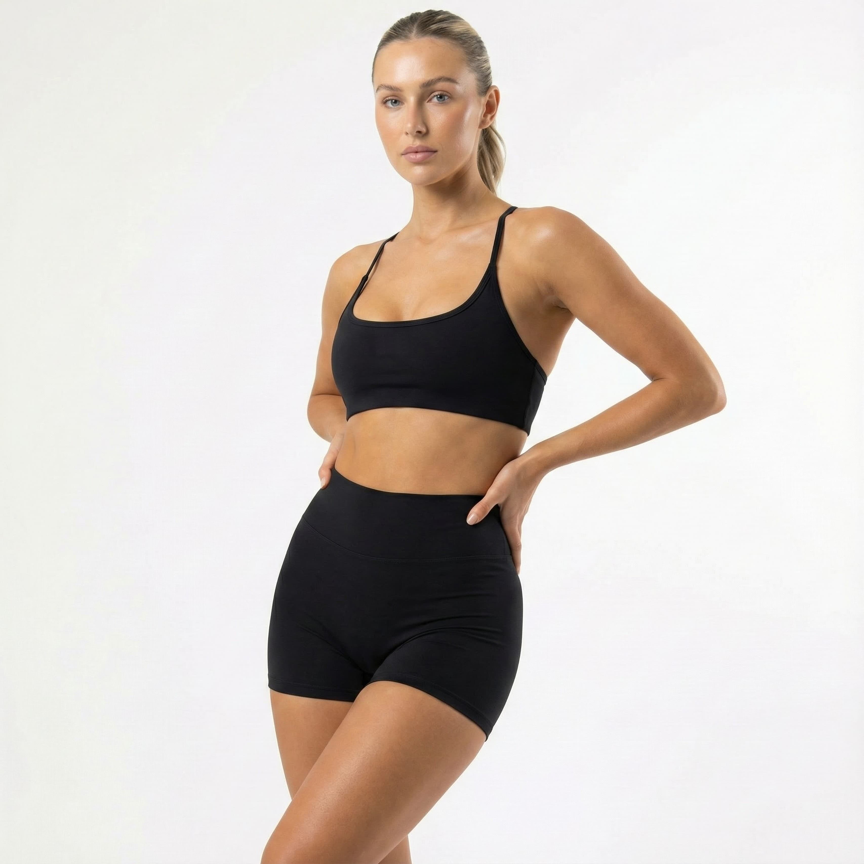 Woman in black two-piece set, studio shot