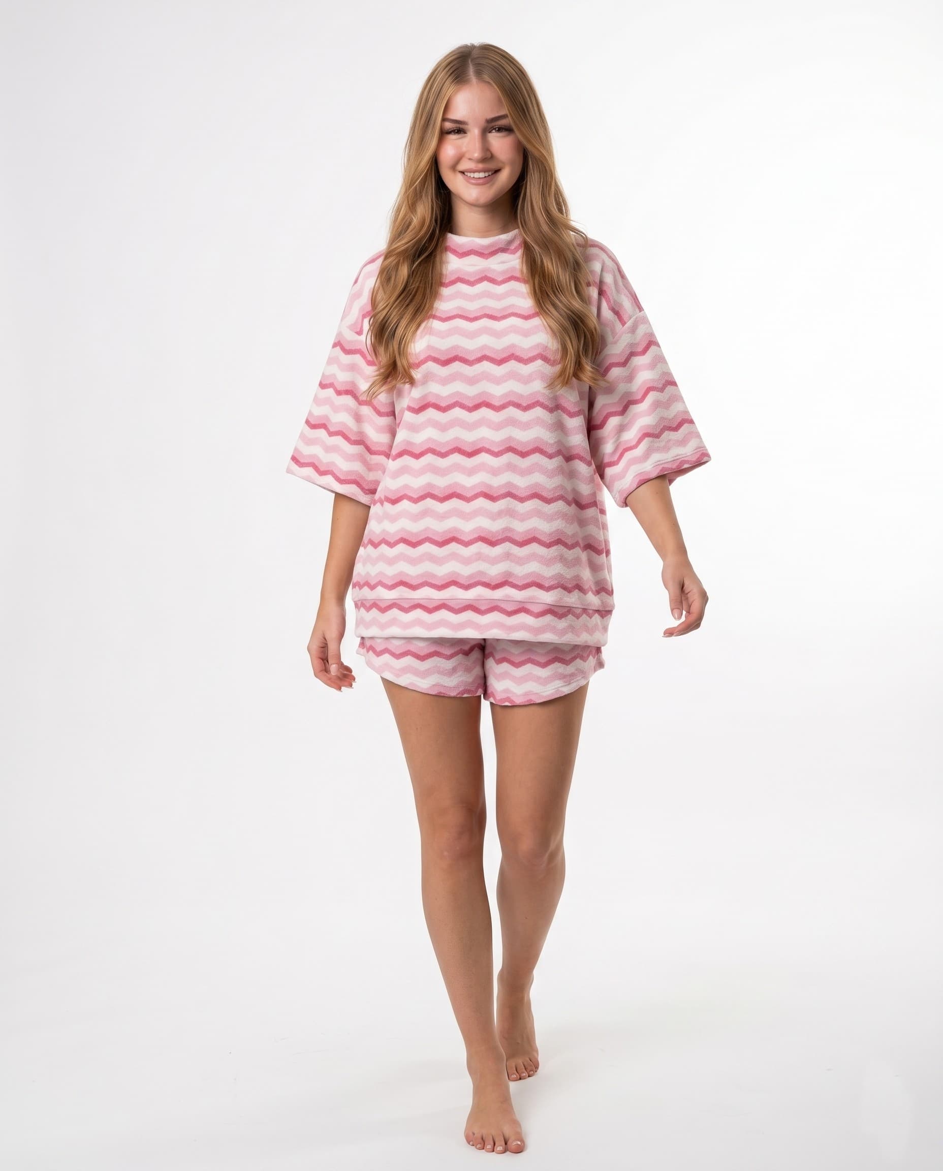 Woman in pink wave pattern shirt and shorts set, studio shot