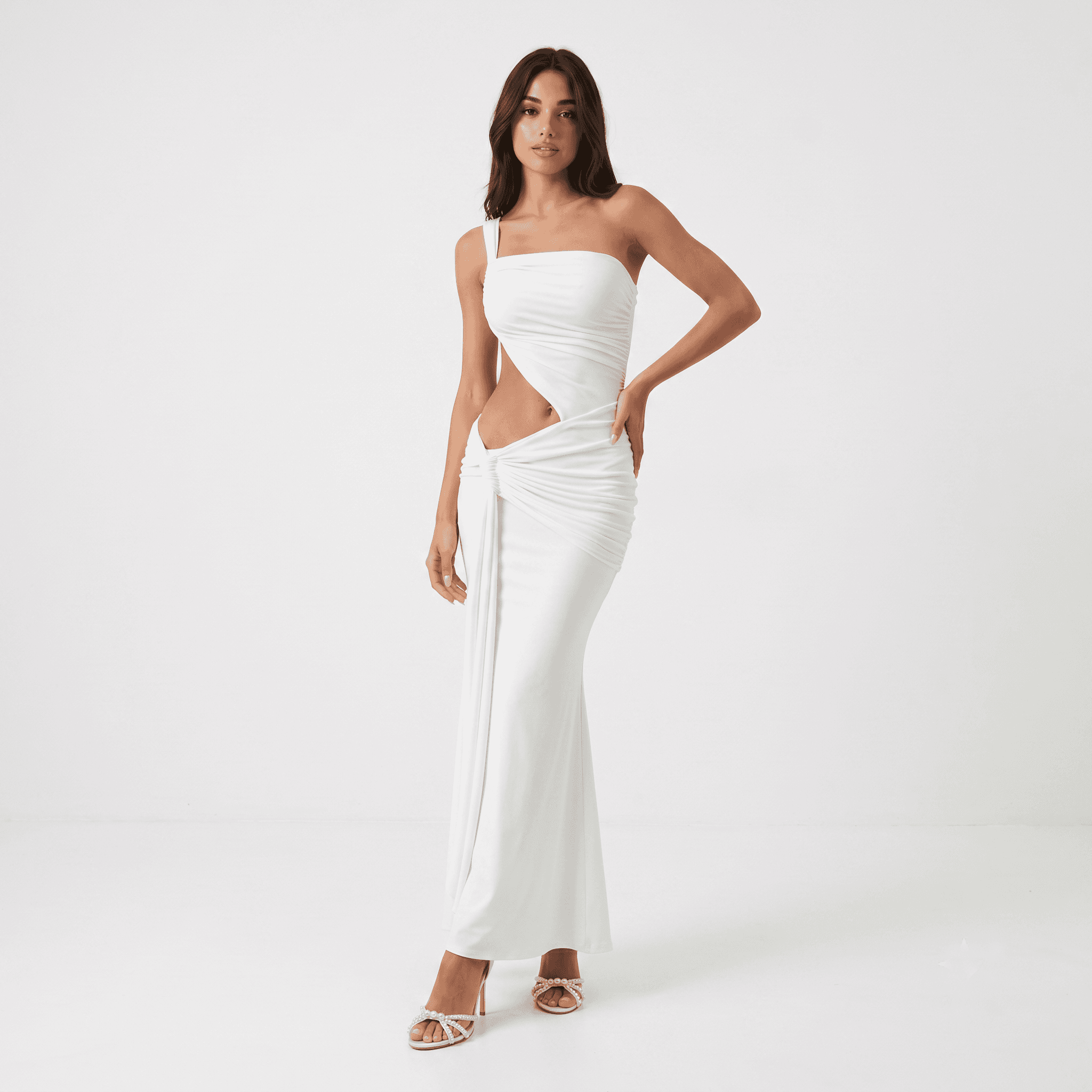 Woman in white one shoulder cutout maxi dress, side pose