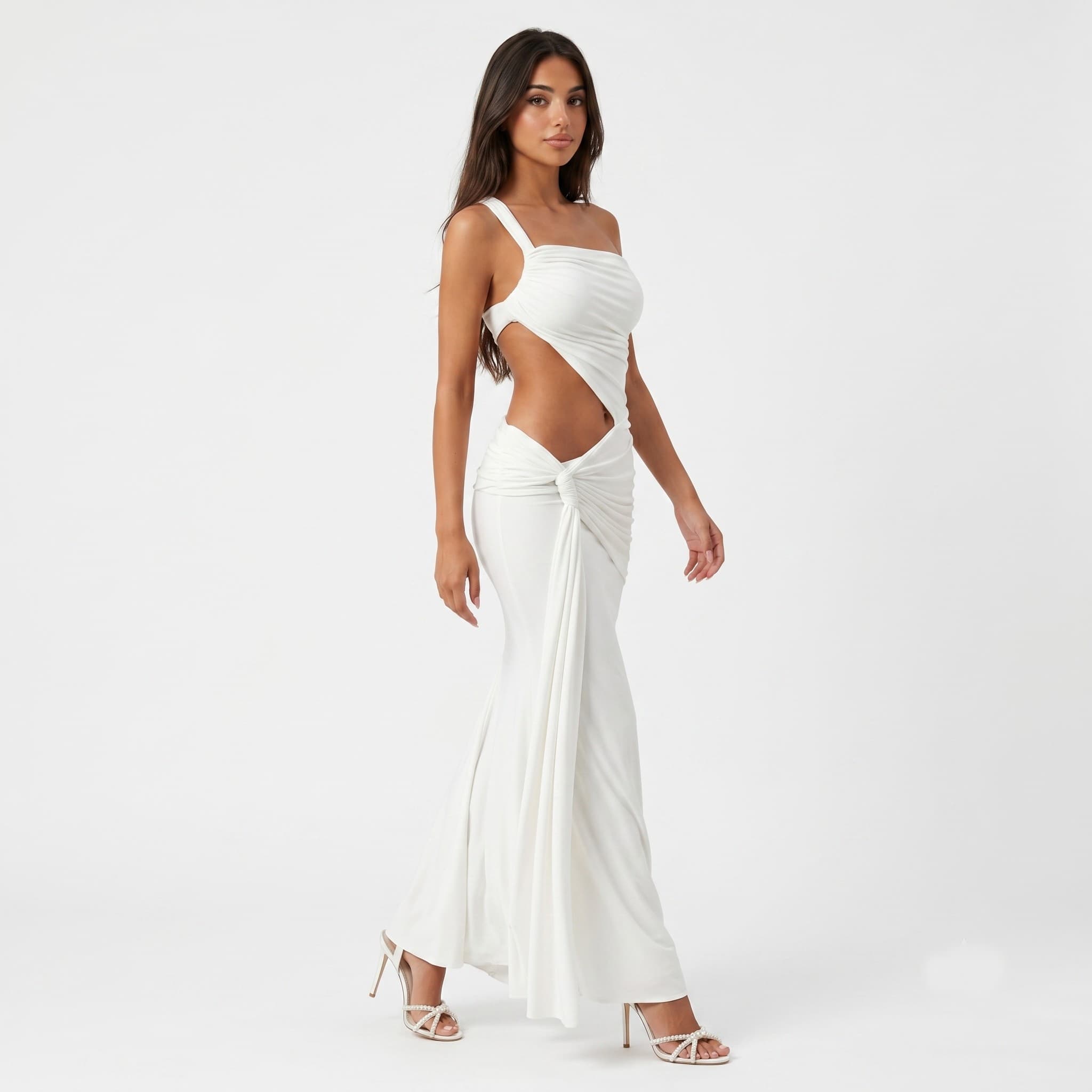 Woman in white one shoulder cutout maxi dress, side pose