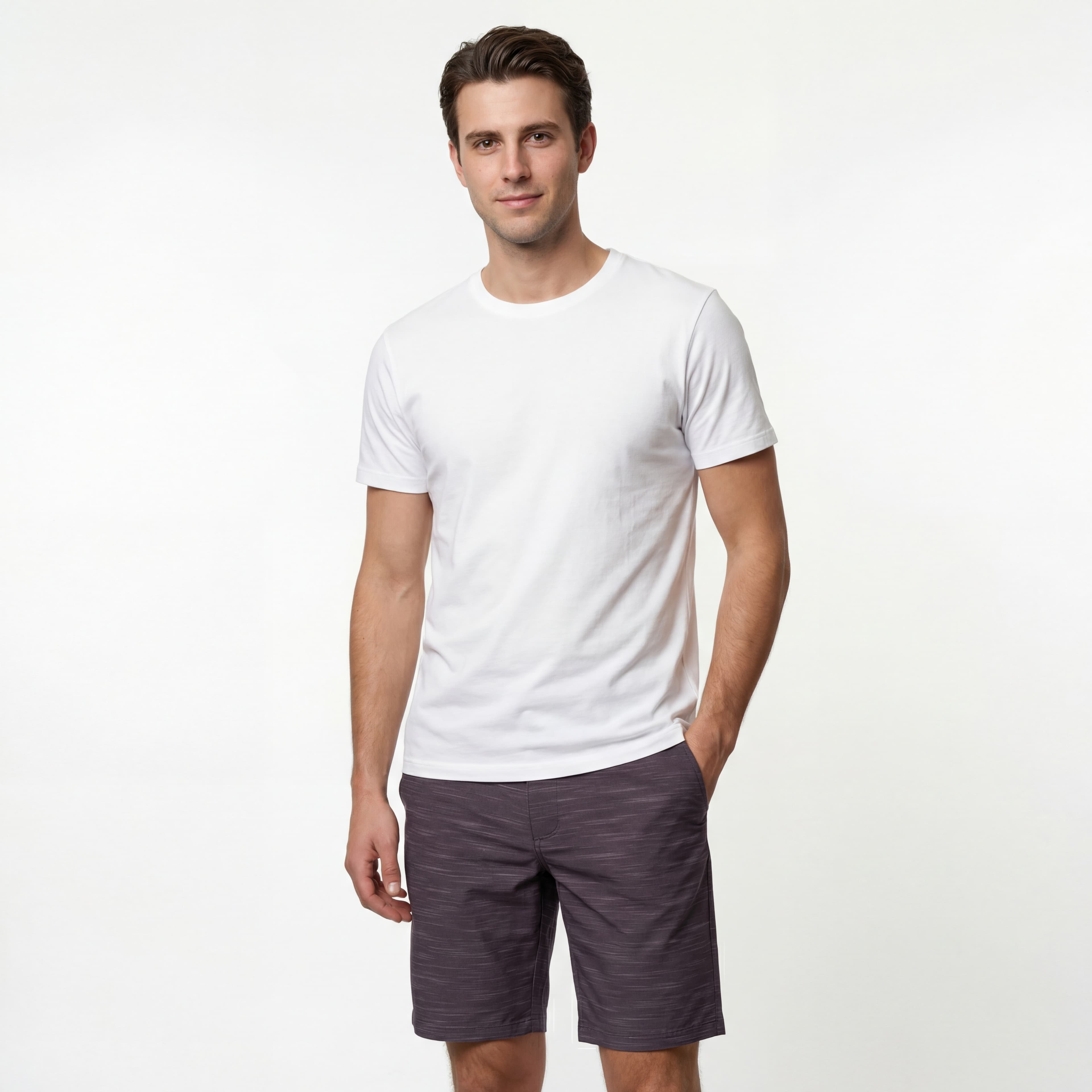 Man in white shirt and gray shorts, studio shot