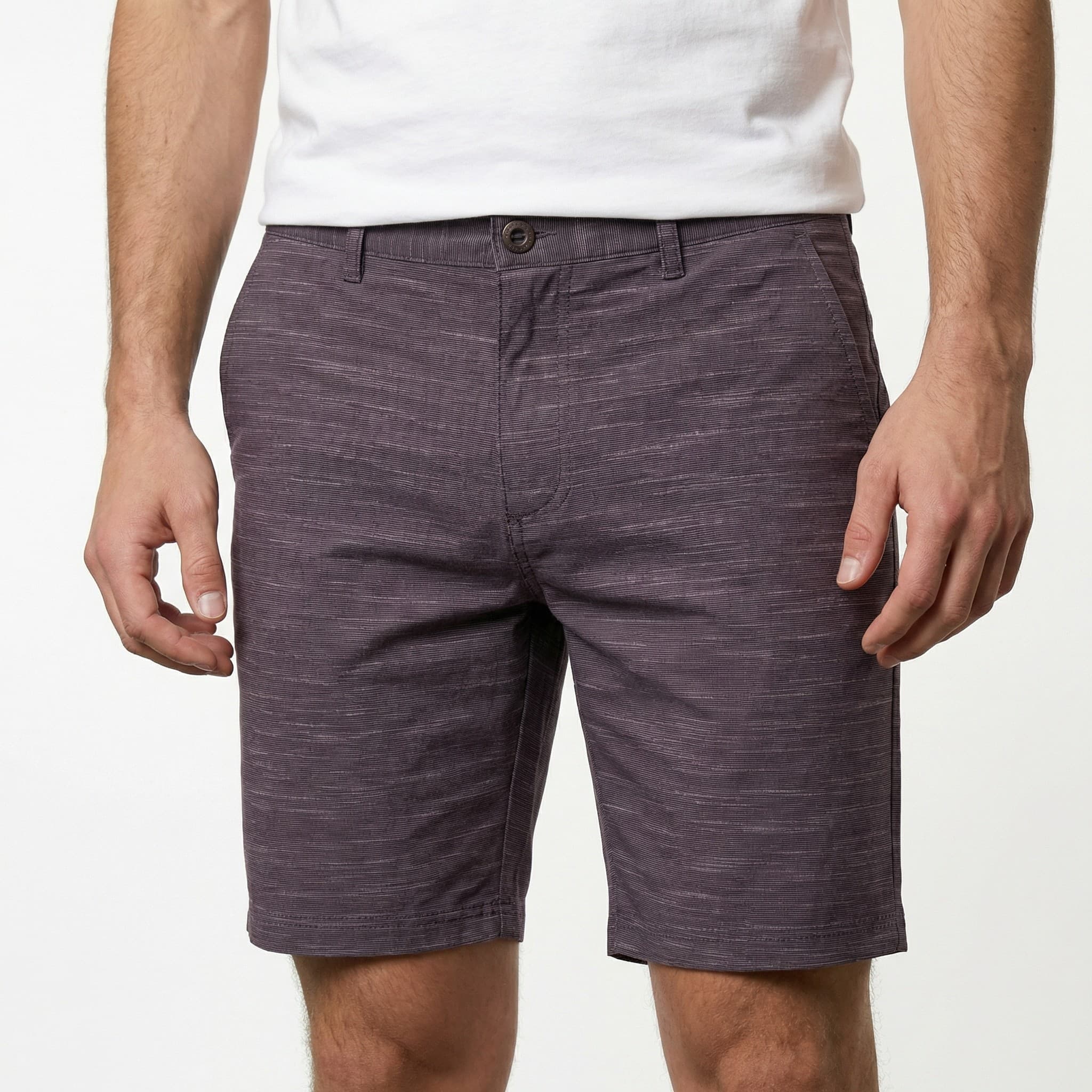Man in white shirt and gray shorts, studio shot