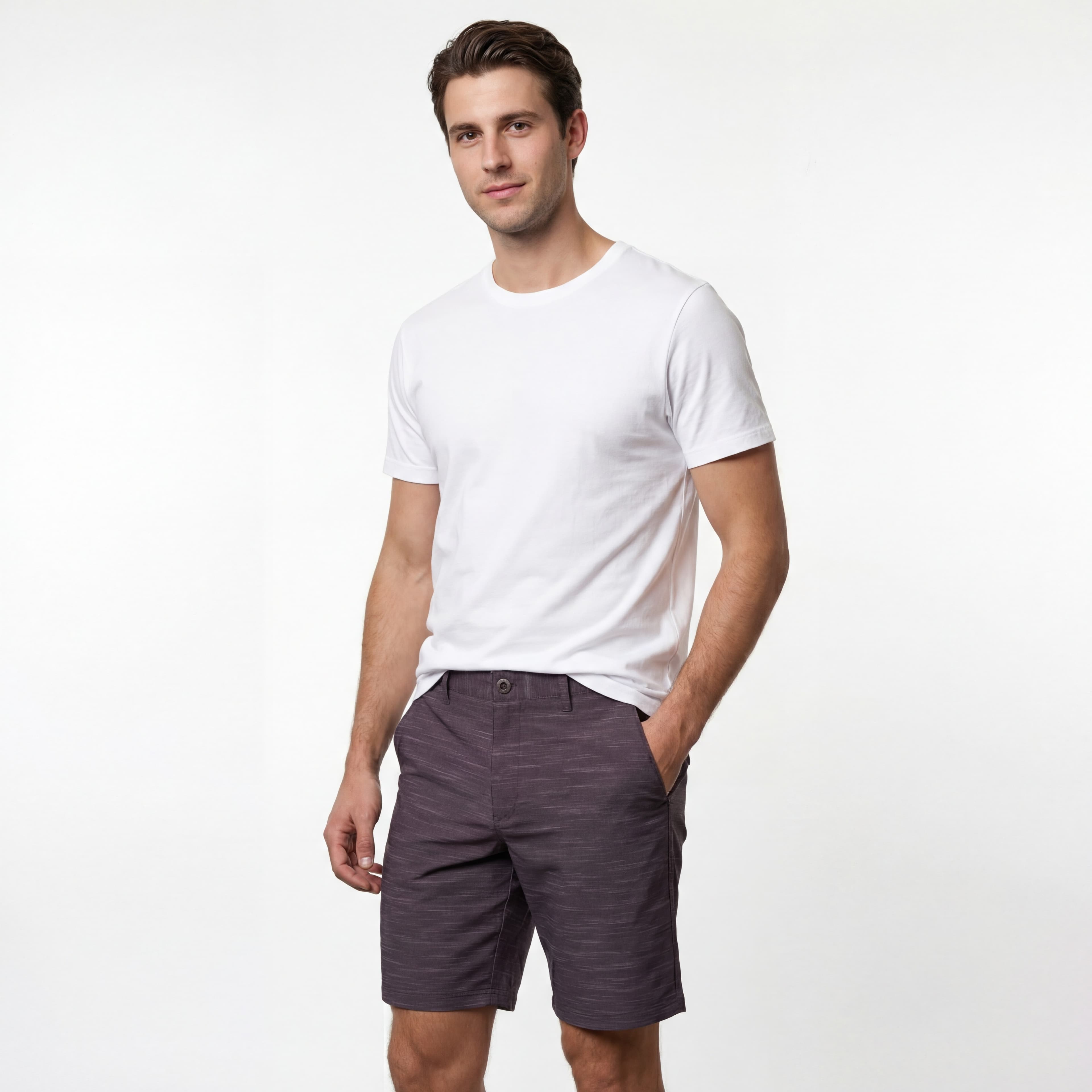 Man in white shirt and gray shorts, studio shot